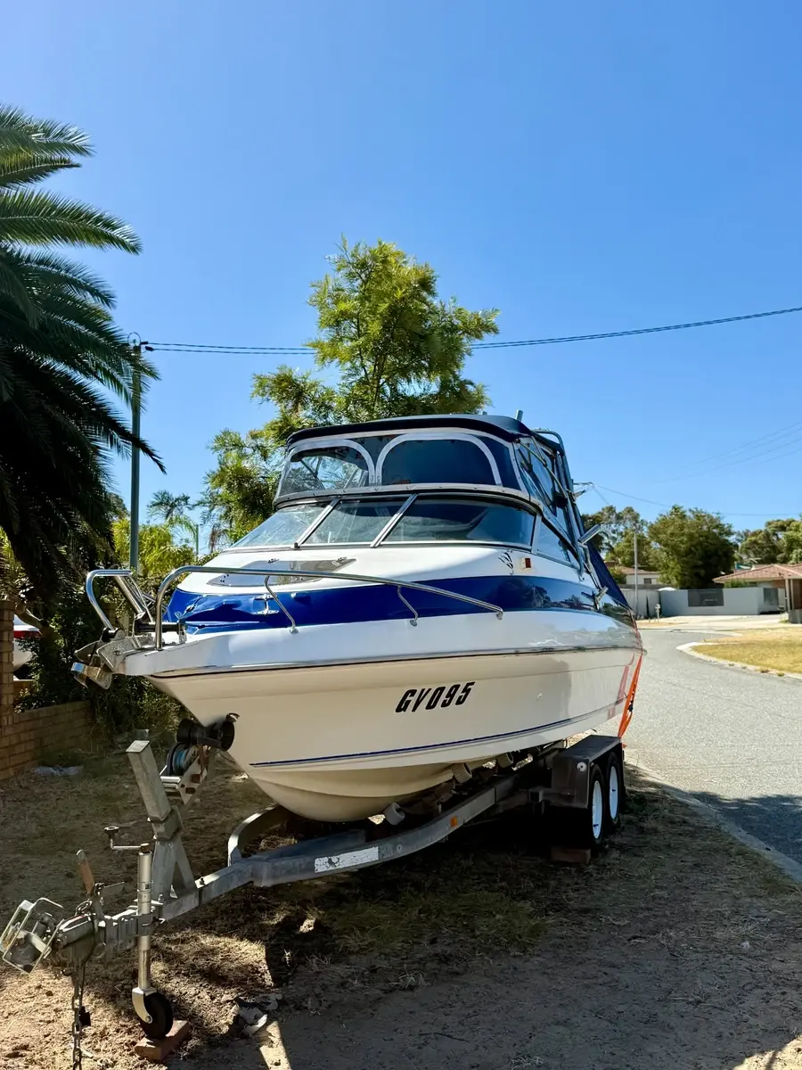 Paint correction boat Perth WA — blue and white cruiser on driveway