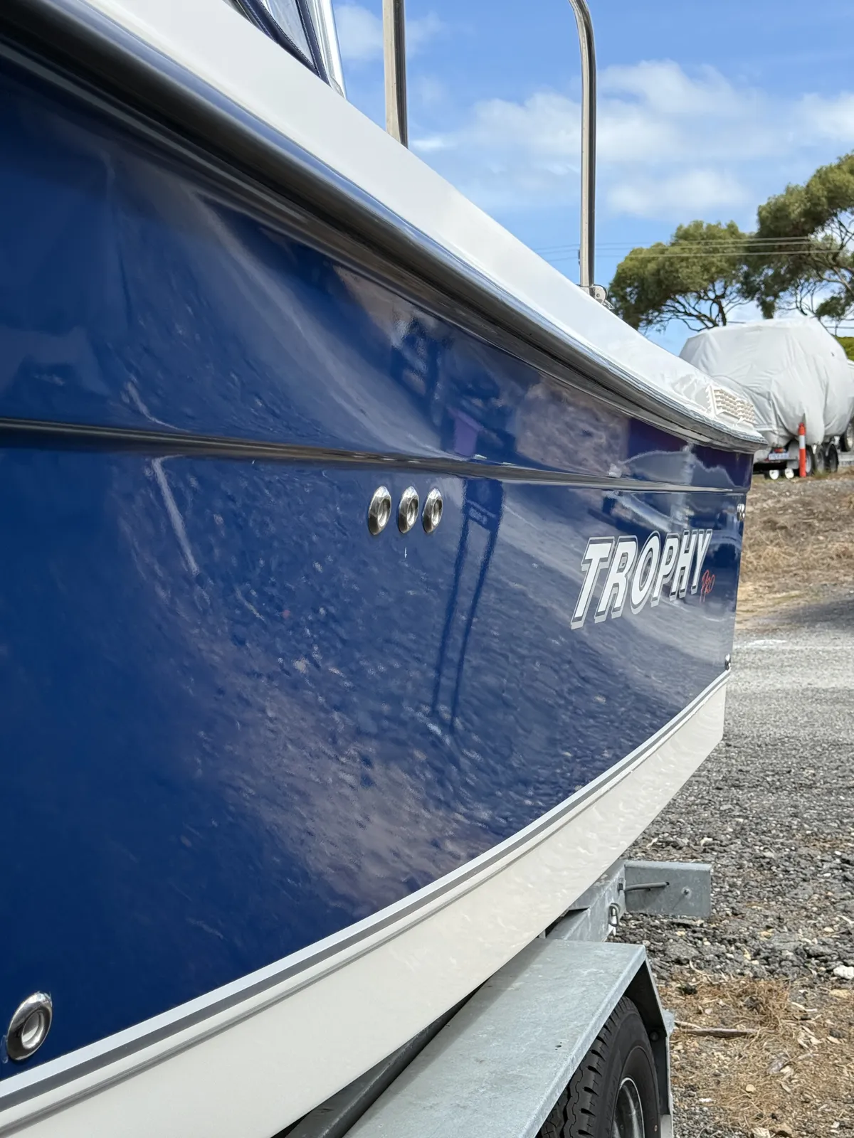 Trophy Pro boat with deep blue hull polished to a high-gloss finish by Foam on Wheels Boat Detailing Perth